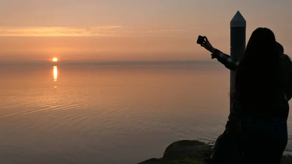 people taking selfie of sunset