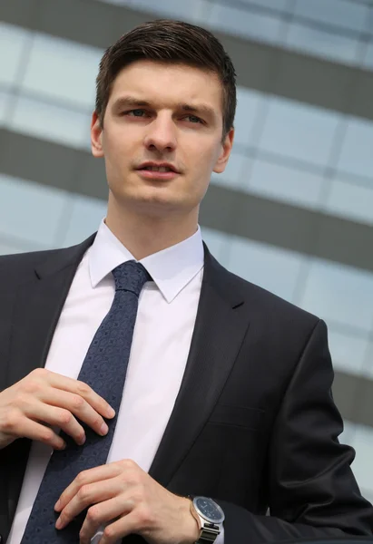 Handsome young businessman sitting in his car — Stock Photo, Image