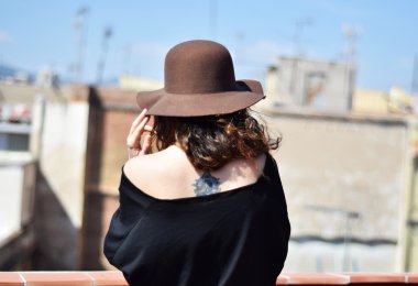 Yalnız genç kadın kahverengi şapkalı düşünme geri Teras, Barcelona, Gotik Semti üzerinden