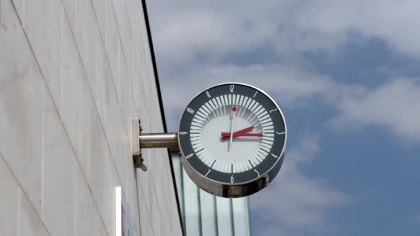 Train station ticking wall clock against cloudy sky — Stock Video