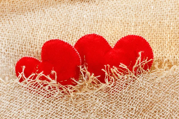 Texture of sackcloth close up and heart shape from felt. — Stock Photo, Image