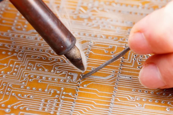 Soldering iron and circuit board — Stock Photo, Image
