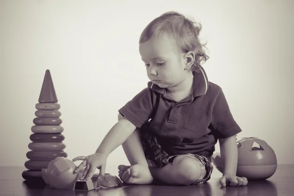 Happy baby boy playing with toy — Stock Photo, Image