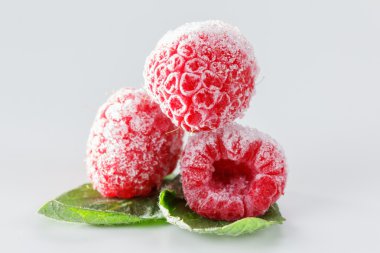 Frozen raspberries with mint leaves on white clipart