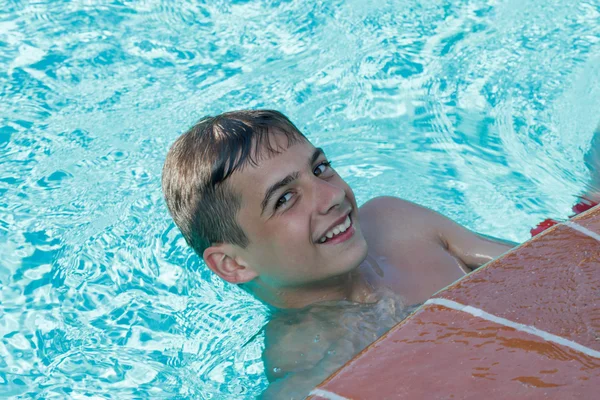 Adolescente chico bucea y nada en la piscina — Foto de Stock