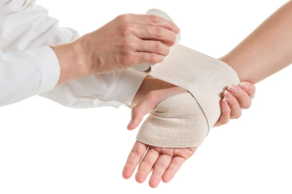 Doctor imposes an elastic bandage to the patient's hand — Stock Photo, Image