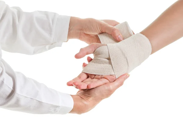 Doctor imposes an elastic bandage to the patient's hand — Stock Photo, Image