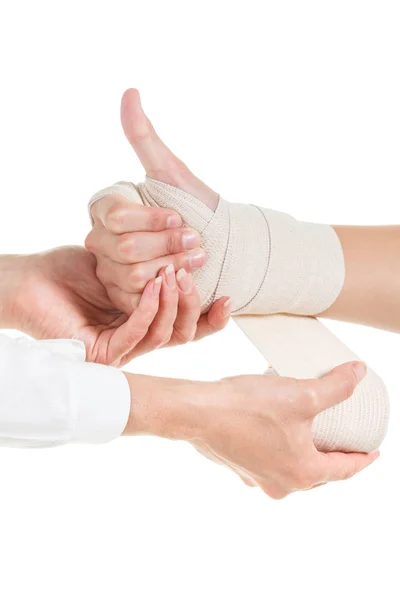 Doctor imposes an elastic bandage to the patient's hand — Stock Photo, Image