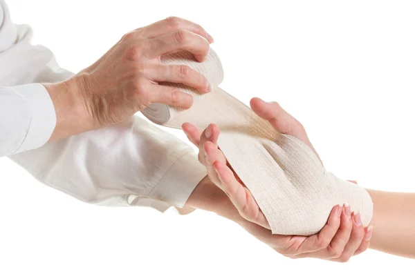 Doctor imposes an elastic bandage to the patients hand — Stock Photo, Image