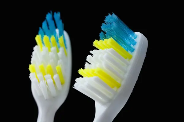 Set of colorful toothbrushes over black — Stock Photo, Image