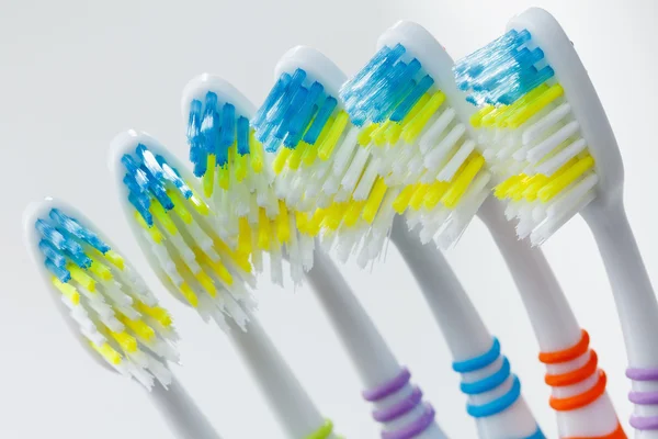 Set of colorful toothbrushes over white — Stock Photo, Image