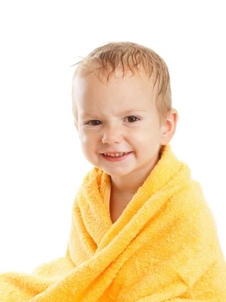 Happy baby wearing yellow towel sitting after bath or shower. — Stock Photo, Image