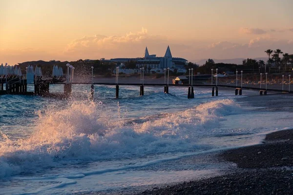 Orange sunset ocean pier and summer. horizon wave