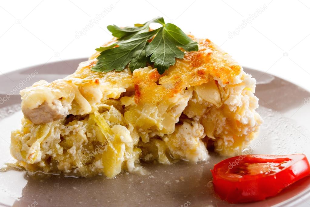 Casserole, squash and meat, fried with cheese, cottage cheese in a glass.