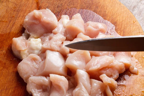 Chicken cubes diet on the kitchen cutting board Stock Photo