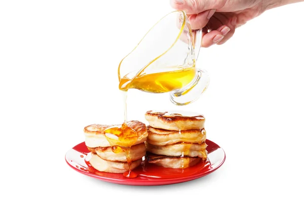Chef pours sweet syrup on pancakes. White background — Stock Photo, Image