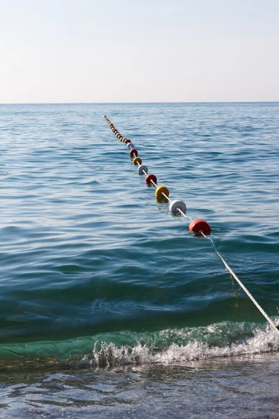 Buoy rope barrier on the water with floats — Stock Photo, Image