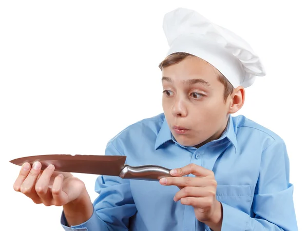 Teenager chef really surprised failure with a knife. Isolated studio — Stock Photo, Image