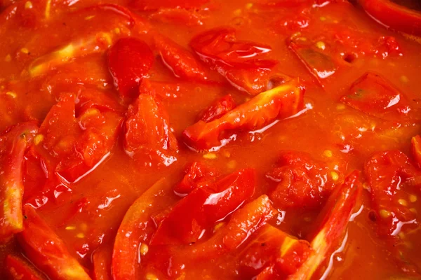 Bunch of fresh red tomatoes sliced stewed in a pan — Stock Photo, Image