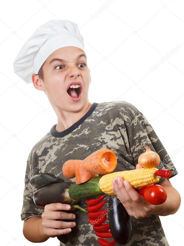 Humorous portrait of a teen boy chef with rifle vegetables, screaming cheers