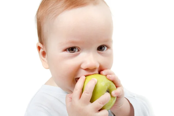 Baby eating green apple. Royalty Free Stock Photos