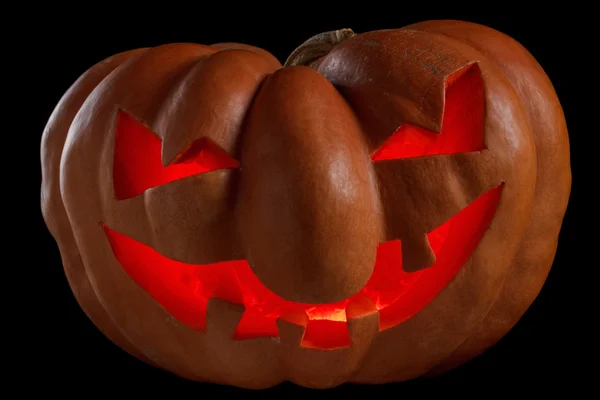 Halloween pumpkin Jack O Lantern shiny inside on black — Stock Photo, Image