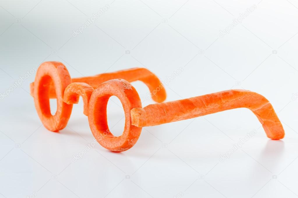 Concept glasses of carrot, benefits view.