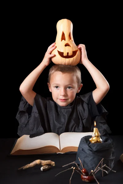 Boy wearing halloween costume with pumpkin — Stock Photo, Image