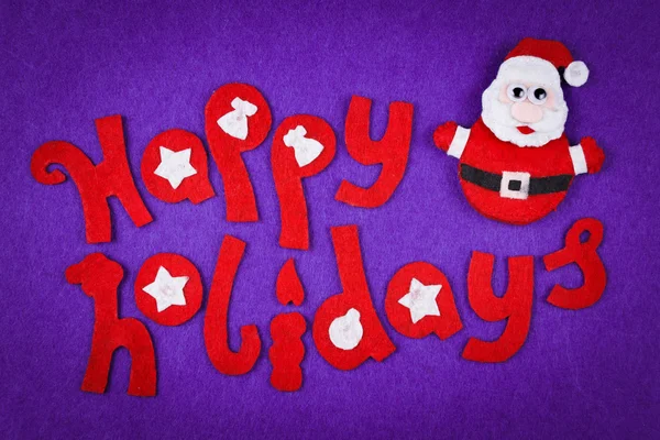 Vánoční koncepce, dekorativní nápis vyrobena z plsti a hračky Santa — Stock fotografie