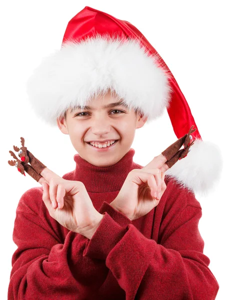 Retrato de feliz teen menino no Santa chapéu com veado brinquedo até isolado no branco — Fotografia de Stock