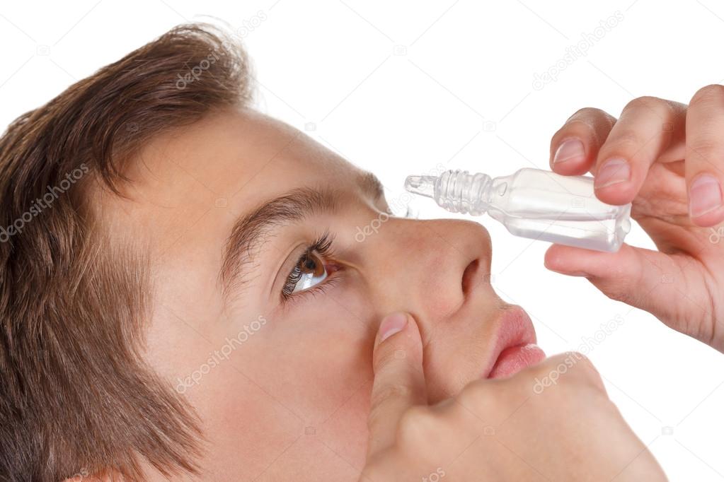 Boy applying eye drop