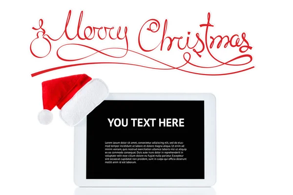 クリスマス サンタ帽子、白い背景に分離されたコンピューターをタブレット — ストック写真