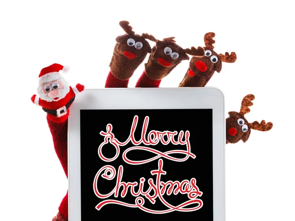 Vánoční koncepce hračky Santa Claus a sobů s dárkem v rukou touchpad — Stock fotografie