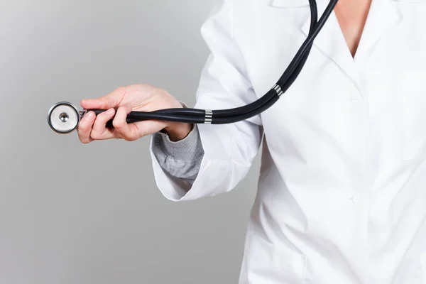 Doctor with stethoscope in the hand, medical uniforms — Stockfoto