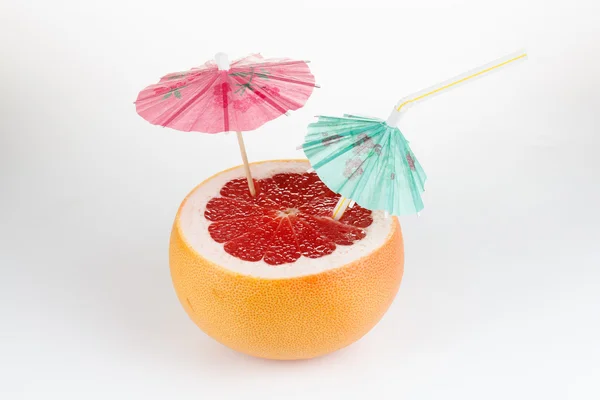 Cut grapefruit cocktail with umbrella, on white — Φωτογραφία Αρχείου