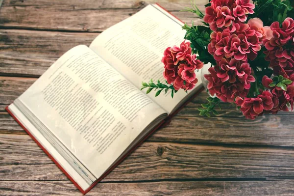 Romantischer Hintergrund mit Tasse Tee, Fliederblumen und offenem Buch über weißem Tisch — Stockfoto