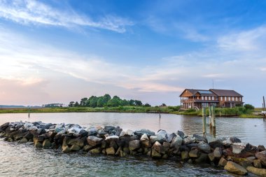 Large beach home on the Chesapeake Bay in Maryland during Summer clipart
