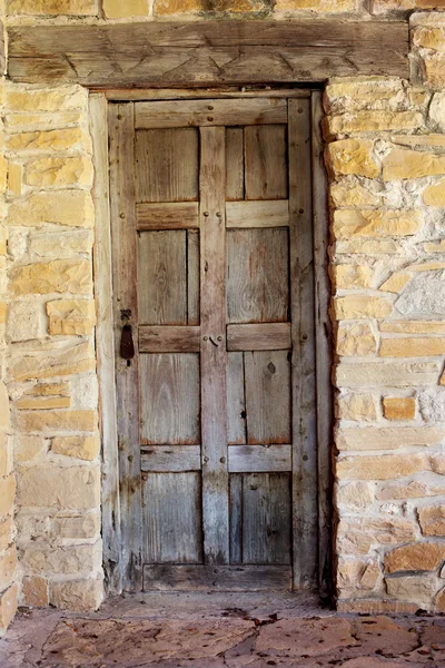 Porte en bois contre mur de pierre usé — Photo