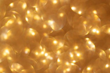 Bulanık altın rengi pulların soyut arkaplanı. Bokeh. Şık.