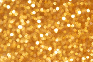 Parlak bir parıltıyla altın pullu bokeh. Şenlik havası. Bulanık arkaplan.