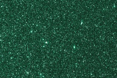 Işıldayan yeşil pulların soyut arkaplanı parlak bir parıltıyla. Tatilin atmosferi.