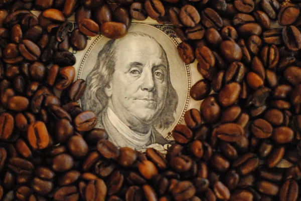 Dollars covered with coffee beans — Stock Photo, Image