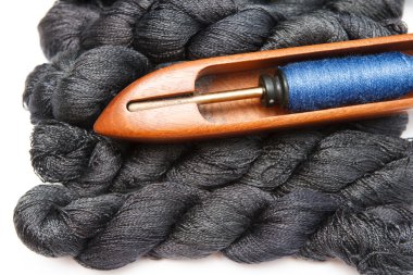 Renkli iplikler ile mekik üzerinde beyaz izole iğne işi için dokuma