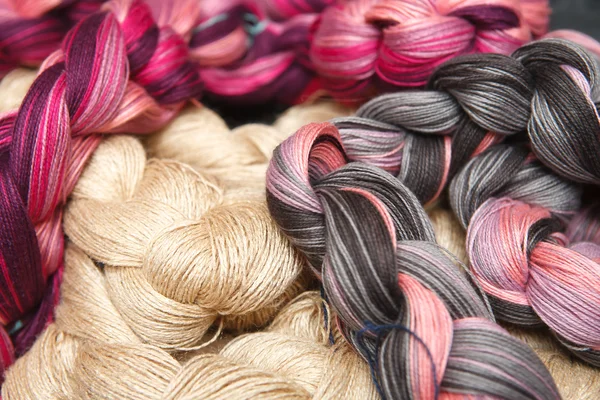 Hanks of pink and beige yarns — Stock Photo, Image