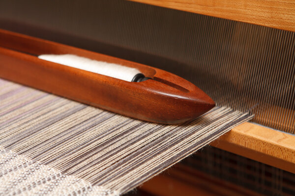 Weaving shuttle on the warp