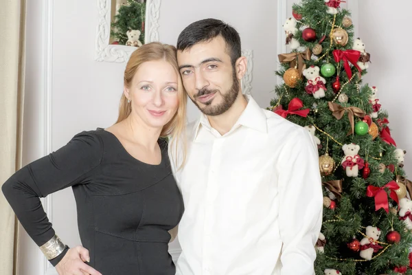 Retrato de un hombre y una mujer cerca del árbol de Navidad . — Foto de Stock