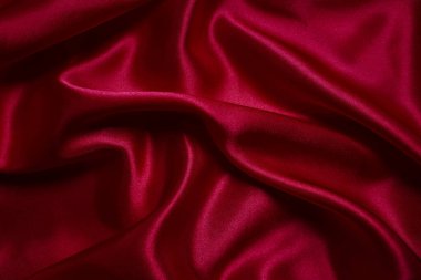 Kırmızı ipek ya da saten lüks kumaş dokusu soyut arkaplan olarak kullanılabilir
