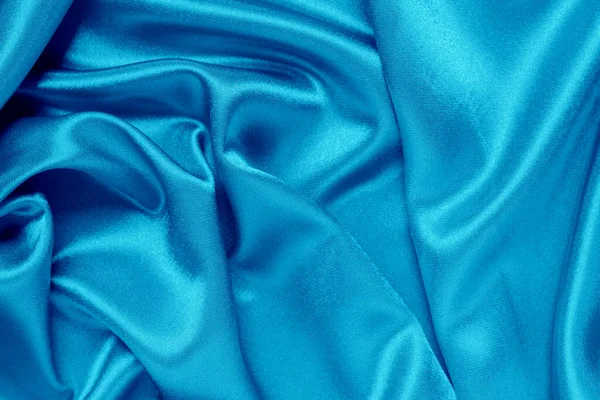 Pürüzsüz mavi ipek arka plan olarak kullanılabilir