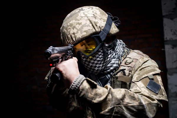 Man in military uniform with gun in his hand — Stock Photo, Image