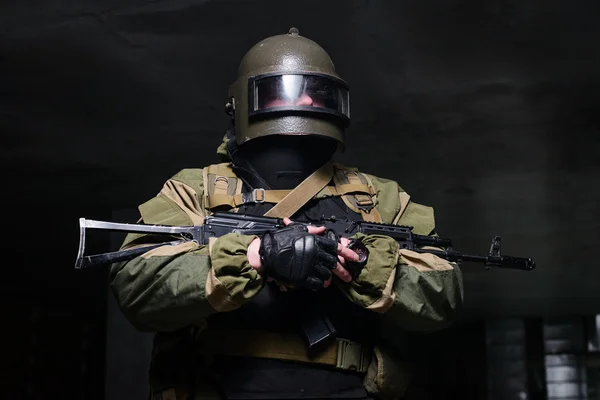 Russian soldier in helmet and flak jacket with weapon